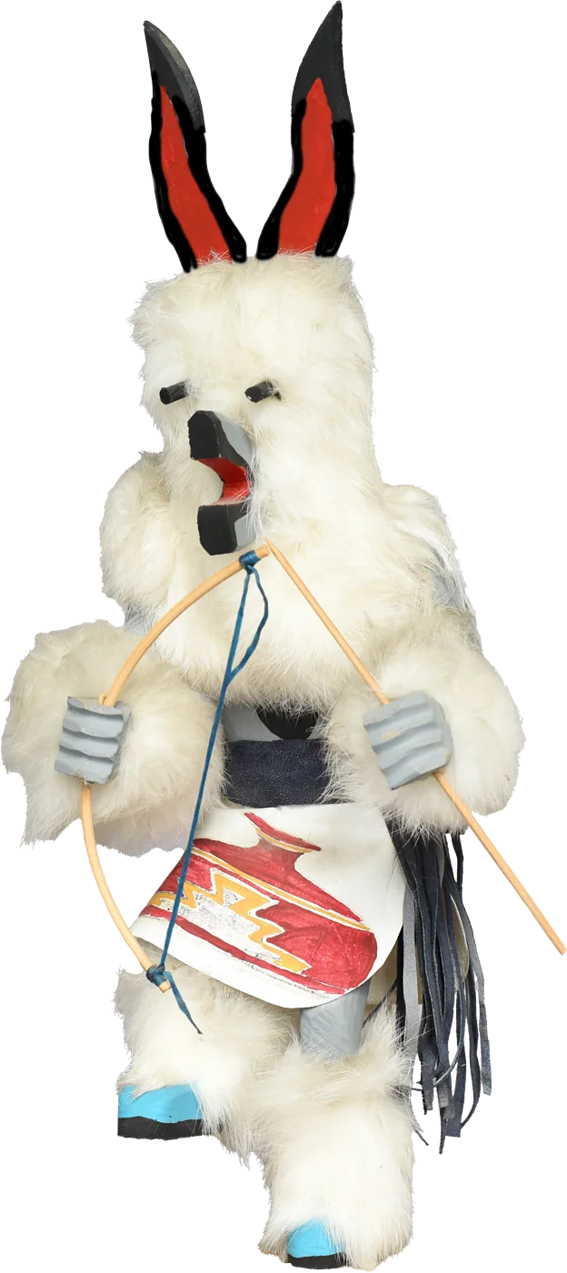 The kachina figure of Brighidán — white fur, black-and-red ears, holding a bow
