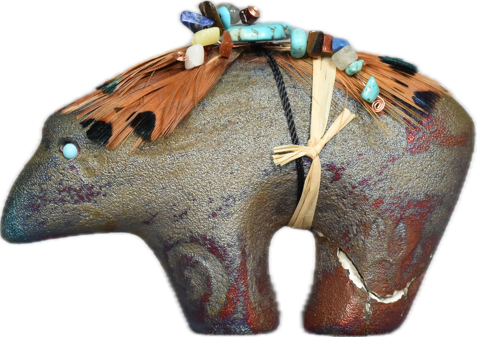 The figure of Estremoz — a stone bear fetish carving with turquoise inlay and a bundle tied across its back