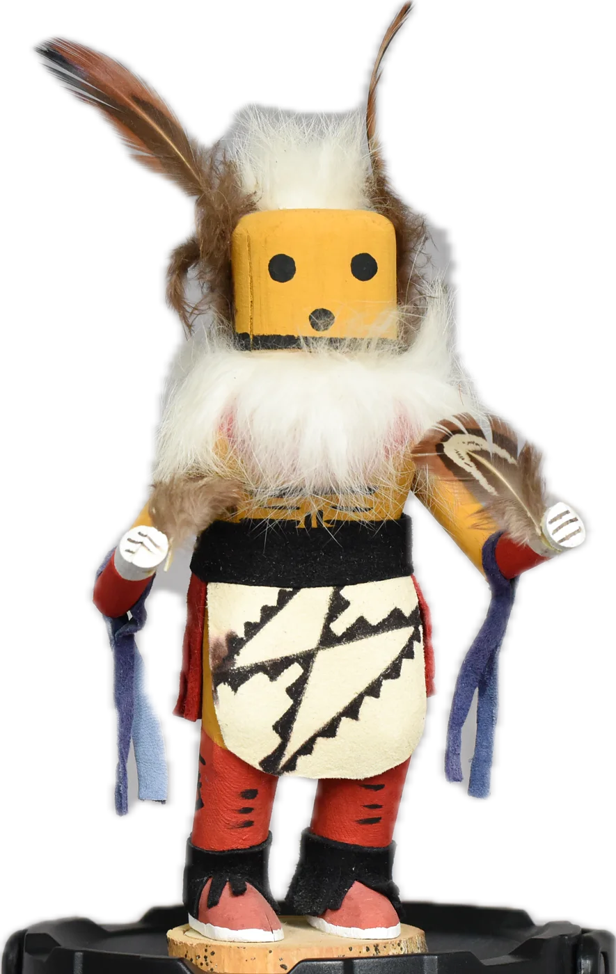 The kachina figure of Finnaghall — square yellow face, tall feathers, white fur beard